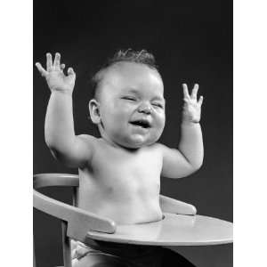 Baby Sitting in High Chair, Laughing, Hands Raised in Air Photographic 