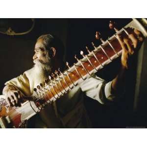  Portrait of an Elderly Man Playing the Sitar, India 