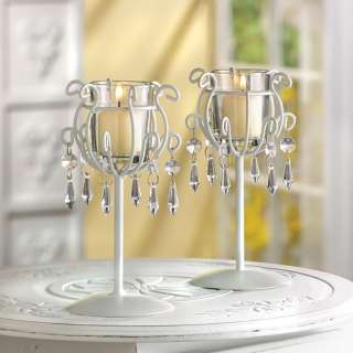  drops dangle from sleek ivory finished wrought iron candle stands 